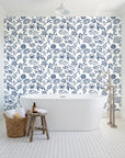 Quiet Reef Navy sea life wallpaper behind a freestanding tub in a bright coastal bathroom
