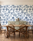 Quiet Reef Navy sea life wallpaper in a farmhouse dining room with a sage sideboard and rustic trestle table
