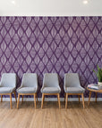 Reed & Smoke Plum geometric wallpaper behind a row of upholstered chairs in a bright clinic waiting room