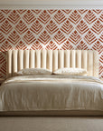 Rising Arrow Terracotta geometric wallpaper behind a channel-tufted bed in a calm primary bedroom