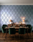 Rosewater Retreat Navy damask wallpaper in a dark moody dining room with a candlelit table