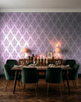 Rosewater Retreat Plum damask wallpaper in a dark moody dining room with a candlelit table