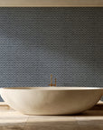 Sage Trellis Charcoal geometric wallpaper creating ambiance in a serene spa bathroom