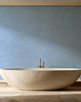 Sage Trellis Dusty Blue geometric wallpaper creating ambiance in a serene spa bathroom