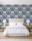 Secret Arbor Midnight damask wallpaper behind a queen bed in a bright coastal bedroom