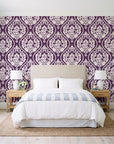 Secret Arbor Plum damask wallpaper behind a queen bed in a bright coastal bedroom