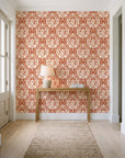 Secret Arbor Terracotta damask wallpaper behind a console table in a light entry hallway