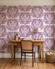 Serene Blossom Rose damask wallpaper behind a vintage writing desk in a cozy craft-room home office