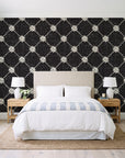 Shadow Garden Onyx lattice floral wallpaper behind a queen bed in a bright coastal bedroom