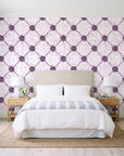 Shadow Garden Plum lattice floral wallpaper behind a queen bed in a bright coastal bedroom