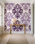 Silent Bouquet Plum damask wallpaper behind a console table in a light entry hallway