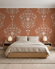 Silent Spring Terracotta damask wallpaper behind a low platform bed in a serene Japandi bedroom