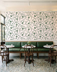 Sketch Anemone Fern sketched anemone wallpaper above a green leather banquette in a sunlit neighborhood cafe