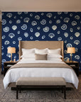 Sketched Seashells Midnight seashell wallpaper behind the headboard of a king bed in a contemporary hotel guest room