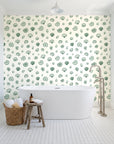 Sketched Seashells Sage seashell wallpaper behind a freestanding tub in a bright coastal bathroom