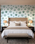 Sketched Seashells Sage seashell wallpaper behind the headboard of a king bed in a contemporary hotel guest room