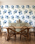 Sky Memory Midnight watercolor floral wallpaper in a farmhouse dining room with a sage sideboard and rustic trestle table