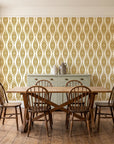 Smoke Ancestry Ochre geometric wallpaper in a farmhouse dining room with a sage sideboard and rustic trestle table