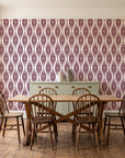 Smoke Ancestry Oxblood geometric wallpaper in a farmhouse dining room with a sage sideboard and rustic trestle table