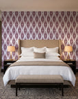 Smoke Ancestry Oxblood geometric wallpaper behind the headboard of a king bed in a contemporary hotel guest room