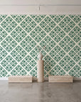 Soft Bouquet Opus Emerald floral damask wallpaper behind a travertine pedestal and vase in a minimal boutique