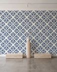 Soft Bouquet Opus Midnight floral damask wallpaper behind a travertine pedestal and vase in a minimal boutique