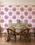 Solstice Bloom Berry folk sun wallpaper in a farmhouse dining room with a sage sideboard and rustic trestle table