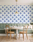 Solstice Bloom Cobalt folk sun wallpaper as a feature wall in a sunlit breakfast nook