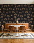 Solstice Rite Eclipse boho rainbow wallpaper in a mid-century dining room with a teak sideboard and tulip table