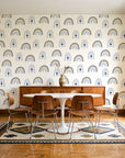 Solstice Rite Midnight boho rainbow wallpaper in a mid-century dining room with a teak sideboard and tulip table