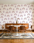 Solstice Rite Plum boho rainbow wallpaper in a mid-century dining room with a teak sideboard and tulip table