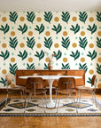 Spice & Frond Emerald leaf frond wallpaper in a mid-century dining room with a teak sideboard and tulip table