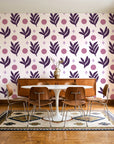 Spice & Frond Plum leaf frond wallpaper in a mid-century dining room with a teak sideboard and tulip table