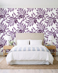 Starfall Plum watercolor leaf wallpaper behind a queen bed in a bright coastal bedroom
