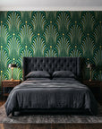 Starlit Swirl Emerald dotted art deco fan wallpaper behind a tufted headboard in a dark, moody bedroom