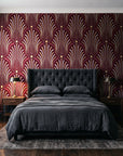 Starlit Swirl Oxblood dotted art deco fan wallpaper behind a tufted headboard in a dark, moody bedroom