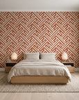 Still Labyrinth Terracotta maze geometric wallpaper behind a low platform bed in a serene Japandi bedroom