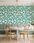 Still Morning Emerald foliage wallpaper as a feature wall in a sunlit breakfast nook