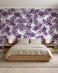 Still Morning Plum foliage wallpaper behind a low platform bed in a serene Japandi bedroom