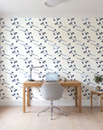Stone Garden Navy sprig wallpaper behind a modern oak desk in a bright home office