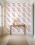 Stone Garden Oxblood sprig wallpaper behind a console table in a light entry hallway