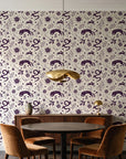 Sun & Moon Parchment celestial folk wallpaper behind a walnut credenza and round table in an elegant dining room