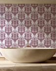 Sunlit Thicket Oxblood damask wallpaper creating ambiance in a serene spa bathroom