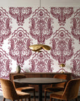 Sunlit Thicket Oxblood damask wallpaper behind a walnut credenza and round table in an elegant dining room