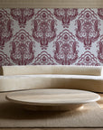 Sunlit Thicket Oxblood damask wallpaper in an elegant living room