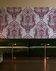 Sunlit Thicket Oxblood damask wallpaper in an intimate luxury cocktail lounge