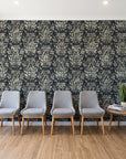 Tranquil Flora Onyx floral damask wallpaper behind a row of upholstered chairs in a bright clinic waiting room