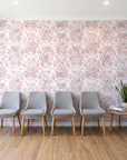 Tranquil Flora Rose floral damask wallpaper behind a row of upholstered chairs in a bright clinic waiting room