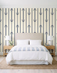Tranquility Tapestry Midnight art deco stripe wallpaper behind a queen bed in a bright coastal bedroom