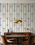 Tranquility Tapestry Midnight art deco stripe wallpaper behind a walnut credenza and round table in an elegant dining room